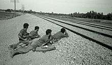 Israeli soldiers in prone position by a railway track