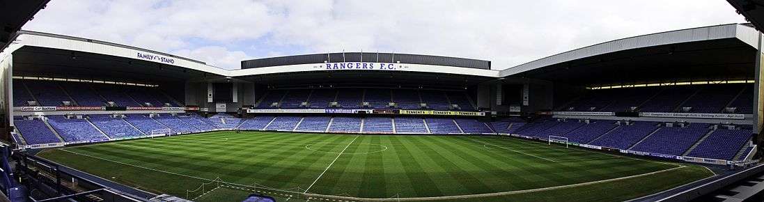 A panorama of Ibrox Stadium taken from the Bill Struth Main Stand, showing from left to right the Broomloan Road Stand, the Sandy Jardine Stand and the Copland Road Stand