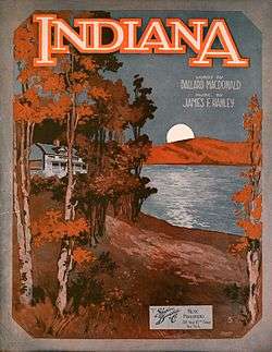 Sheet music cover showing a white house in a forest by a lake. The forest is orange and brown, and the sky is dark blue. On the other side of the lake, the moon is rising. The word "Indiana" is written at the top of the poster. Underneath it, there is a text "Words by Ballard MacDonald, music by James F. Hanley".