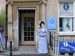 Photograph of a building decorated with Jane Austen posters and paraphernalia, including a mannequin dressed in early 19th-century clothing.