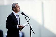 Jens Stoltenberg speaking at a podium.