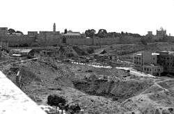 Largely empty land near the Old City wall, Dormition Abbey (on the far right), and Tower of David (center-left).
