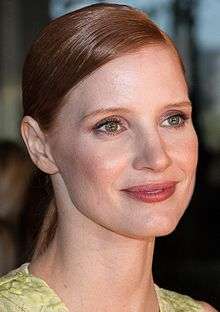 A head shot of Chastain as she smiles away from the camera
