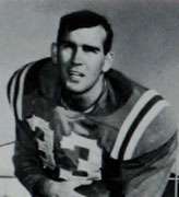 College football player Jim Holder wearing his #33 jersey and posing with a football for a publicity picture