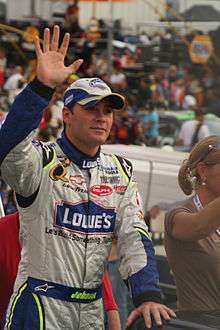 NASCAR driver Jimmie Johnson waves to fans