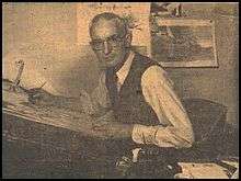 A photograph of Jimmie Frise at his drawing board