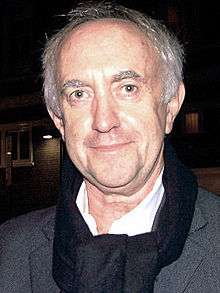 Jonathan Pryce looking to the camera
