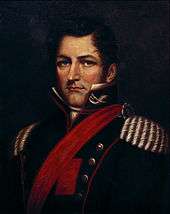 Half-length painted portrait depicting a man with dark blond hair wearing a military tunic with gold epaulets, red piping, a red sash and upraised collar bearing calvary insignia