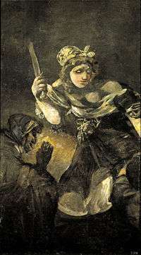 A buxom woman looms out the dark background, nonchalantly holding a short, blunt sword in her right hand. A grotesque servant woman crouches to the left of the image. The head of Holofernes is not visible.