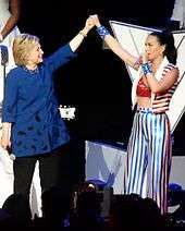 Hillary Clinton and Perry pose with hands connected at a fundraising concert