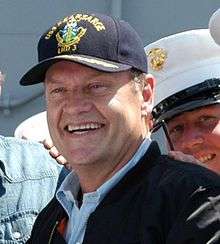 Smiling man outdoors in military baseball cap