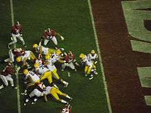 American football players running a running play.