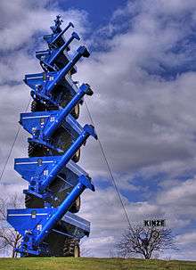 Grain auger carts are stacked vertically, each cart is smaller than the one below it
