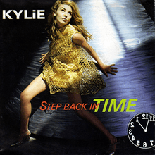 An image of a woman (Kylie Minogue) wearing a gold-like dress, and standing in front of a blue-ish white background with lights. The song title, a backwards clock, and the woman's name is superimposed on the cover.