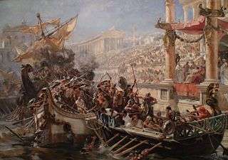 Two ships collide in a flooded arena or stone-lined body of water, and their crew mingle in fight. The shorter boat is powered by oars, the taller by sails. The emperor and crowd look on.