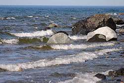 A picture of rocks on a lakeshore