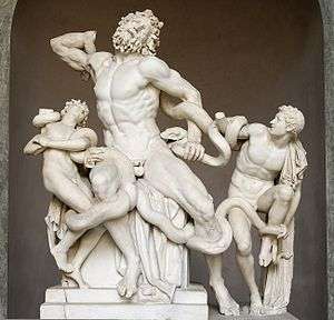 Photograph of a sculpture.  A bearded man and two boys fight to free themselves from sea serpents that entangle them.