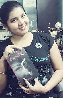 Leema Dhar holding a book