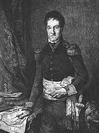 Blank and white print of a hatless man standing next to a desk with his hand on a map. He wears a dark military uniform with epaulettes, a sash around his waist and colored cuffs.