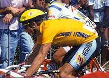 A cyclist wearing a yellow jersey.