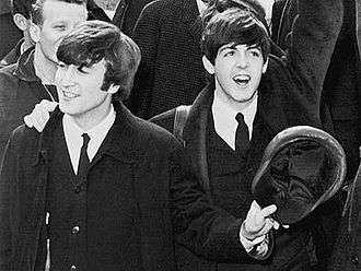 The Beatles arriving at Kennedy airport, with John Lennon holding his cap