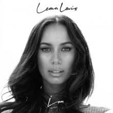 A black and white image of a woman looking at the camera face on. Leona Lewis is written in back in the centre-top. I Am is written in white in the centre-bottom.