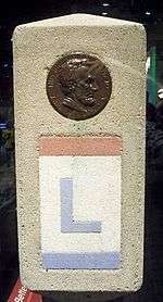 The Lincoln Highway was marked with small concrete obelisks.  Towards the top of the marker was a profile of Abraham Lincoln.  Below the profile, the route is marked with an L painted in red, white, and blue, the colors of the Lincoln Highway.