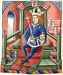 A crowned young man sits on a throne