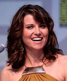 A colored photograph of Lucy Lawless smiling.