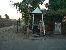 Police post with public fountain and railway used for sugar cane.