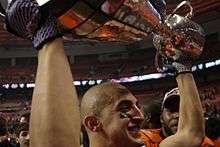 Marco Iannuzzi hoists 99th Grey Cup.