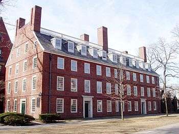 A four story brick building with many windows.