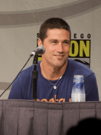 Matthew Fox behind the microphone at a convention.