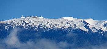  snow-covered peak with observatory domes