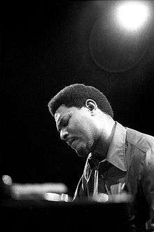 Close-up, worms eye-view of McCoy Tyner at a piano, backlit