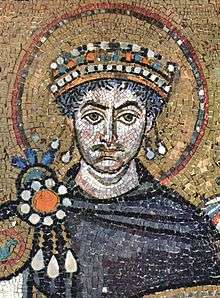 Mosaic depicting the bust of a severe-looking man wearing a crown and an intricate royal purple tunic.