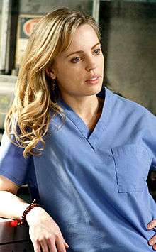 A photo of Sadie Harris in blue surgical scrubs.