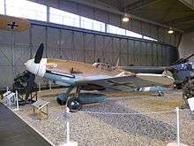 a colour photograph of an aircraft in a museum