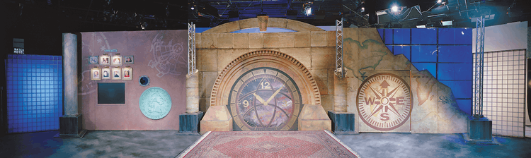 Panorama of the MoneyHunt set, featuring the clock, compass, and coin motif.