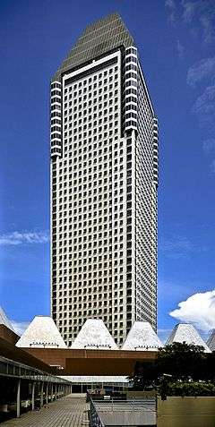 Side view of a 40-story building with a square cross section; the building tapers into a partial pyramid near the roofline.