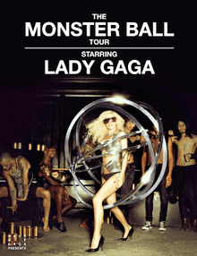 Gaga standing inside a series of metallic rings surrounding her. A crowd is visible behind her.