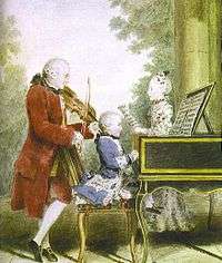  A man in a long red coat, knee-britches and white stockings is playing a violin. A small child dressed in blue sits at the piano or harpsichord. A young woman faces them, holding a sheet of music. In the background there are trees and a pale sky.
