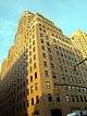  BellTel Lofts, a high-rise clad in yellow stone in an art deco architectural style, viewed from street level