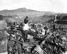 A pile of rubble surmounted by a statue of Buddha