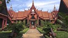 A building in traditional Cambodian style, in front of which is a path and garden.