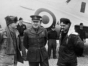Six men in military dress standing in front of an aircraft
