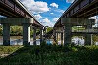 Anthony Henday Drive bridges over the North Saskatchewan River in southwest Edmonton, Alberta. The eastbound bridge includes a pedestrian walkway underneath the bridge.