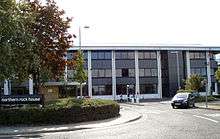 A three storey black and grey building; the headquarters of the bank.