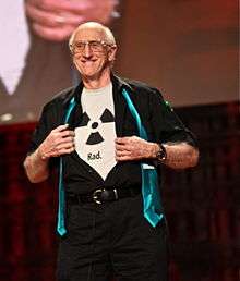 Stewart Brand wearing a shirt bearing the radioactive trefoil symbol with the caption "Rad."