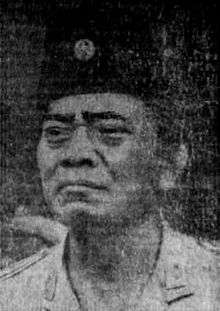 A three-quarter view portrait of General Urip Sumoharjo, the first chief of staff of the Indonesian National Armed Forces. He is wearing a peci hat, also called a songkok, and faces towards the viewer's left.